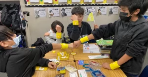 Four QUEST Students on the yellow team showing off their team swag