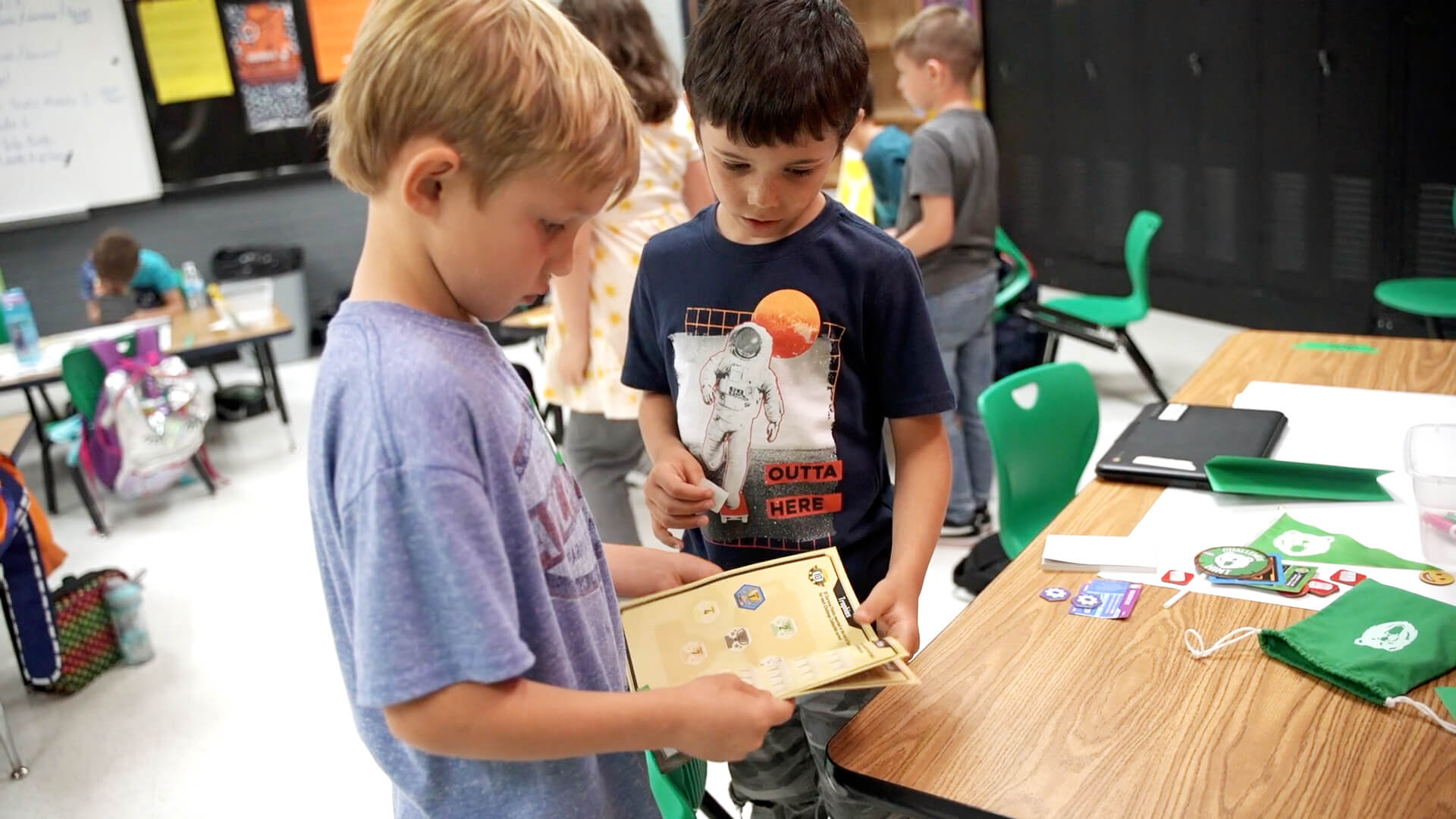 QUEST students looking at the team journal together