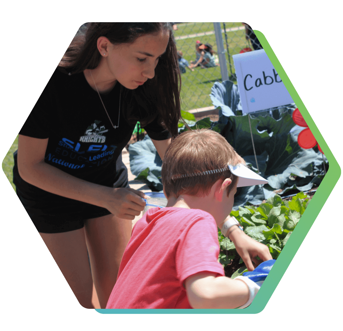 SLED student helping a child in a community garden