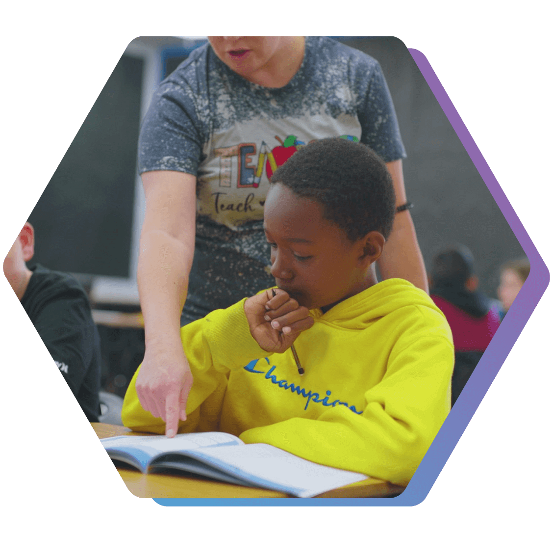 QUEST Panama Buena Vista student receives instruction from a facilitator working through his team journal