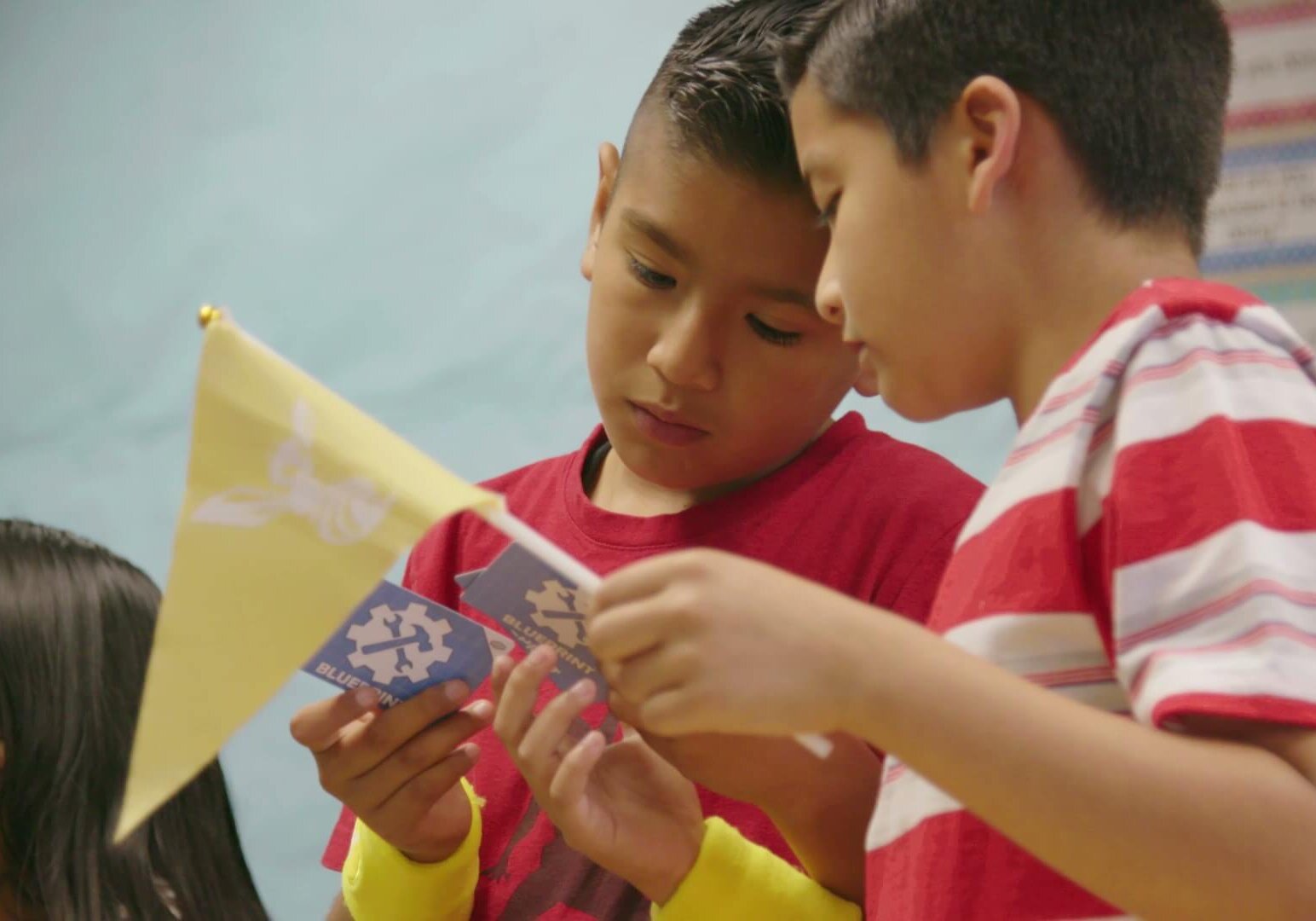 Two students looking at blueprint cards during QUEST