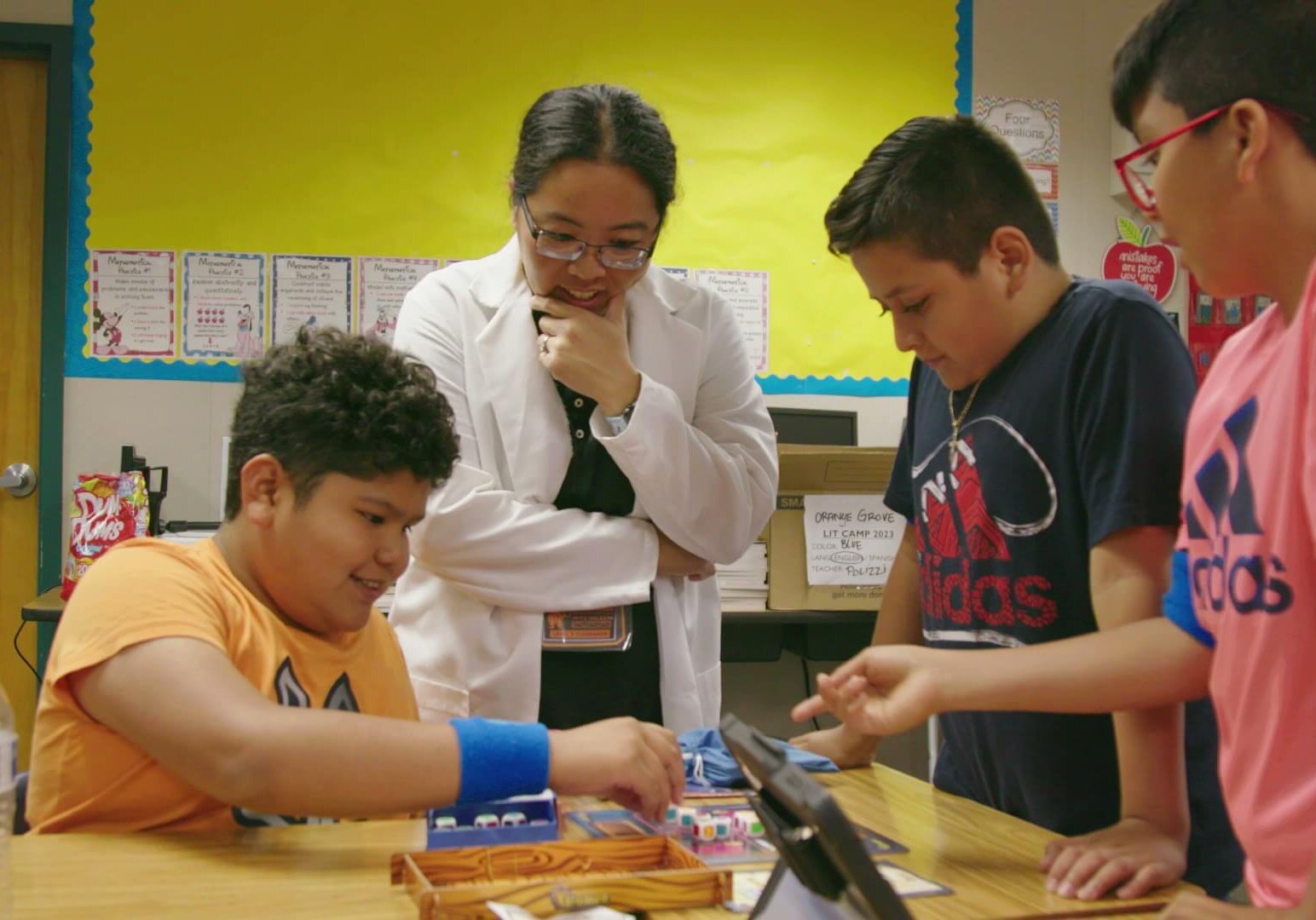 Three students and a teacher playing a QUEST challenge game