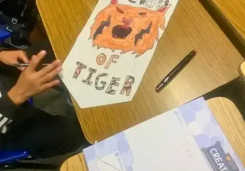 Creators banner decorated with student art of a tiger face