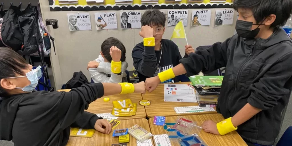 Four QUEST Students on the yellow team showing off their team swag