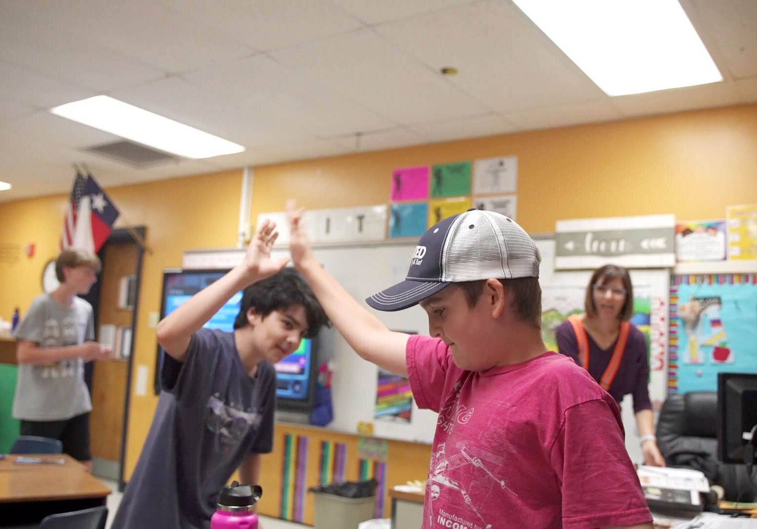 QUEST students high-fiving during a challenge activity