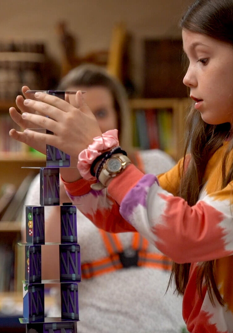 QUEST Student carefully building tower challenge