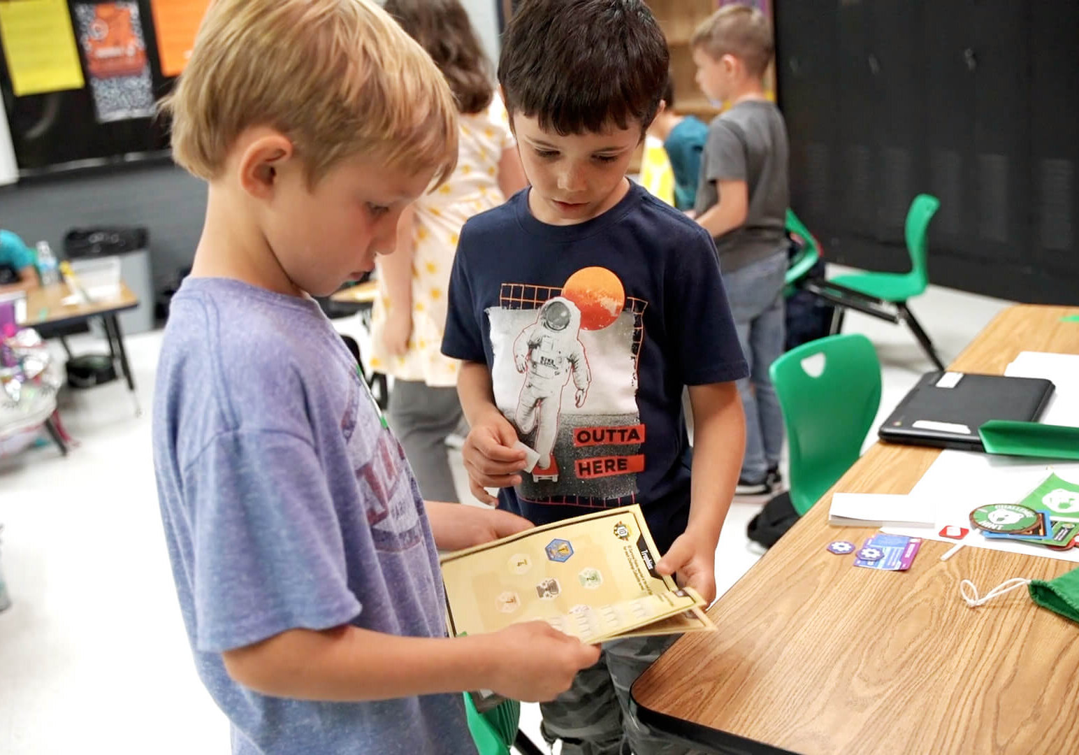 QUEST students looking at the team journal together